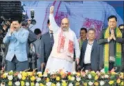  ?? AFP ?? Home minister Amit Shah (centre) , CM Sarbananda Sonowal (right) and Assam BJP chief at a rally in Assam’s Nalbari.