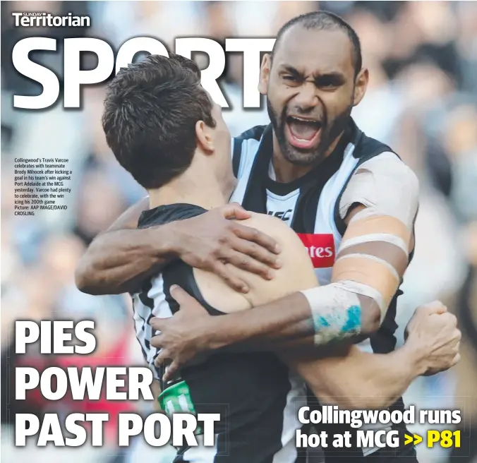  ?? Picture: AAP IMAGE/DAVID CROSLING ?? Collingwoo­d’s Travis Varcoe celebrates with teammate Brody Mihocek after kicking a goal in his team’s win against Port Adelaide at the MCG yesterday. Varcoe had plenty to celebrate, with the win icing his 200th game