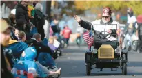  ?? ABBY DREY/SPECIAL TO THE MORNING CALL ?? Members of the Rajah Forks of Delaware Shriners Club from Easton wave to the crowd from their mini cars during the Allentown Halloween Parade in 2010.