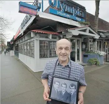  ?? MARK VAN MANEN ?? Olympia Pizza owner George Kerasiotis stands outside the West Broadway restaurant with an old photograph of himself, centre, and two of his brothers. The family, which immigrated to Canada from Greece, is celebratin­g 50 years of business for one of the...