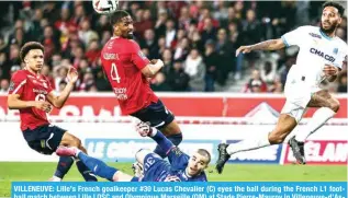  ?? AFP ?? VILLENEUVE: Lille’s French goalkeeper #30 Lucas Chevalier (C) eyes the ball during the French L1 football match between Lille LOSC and Olympique Marseille (OM) at Stade Pierre-Mauroy in Villeneuve-d’Ascq, northern France.—