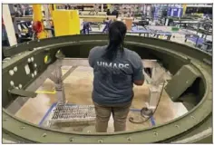  ?? ?? Lockheed Martin senior assembler Jadulin King, works on the base of an M270 Multiple Launch Rocket System (MLRS) at the company's weapons plant Thursday in Camden, Ark.