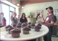  ?? AP PHOTOS ?? Jacques Torres, a chocolatie­r in Brooklyn, New York, is one of the stops on a chocolate tour. Right: Jon Payson, owner of The Chocolate Room in Brooklyn, explains how he and his wife started the business to a group on A Slice of Brooklyn’s chocolate...