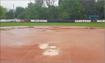  ?? AUSTIN HERTZOG - DIGITAL FIRST MEDIA ?? Spring-Ford’s Ram Park takes on water after storms hit the area and postponed the Pioneer Athletic Conference baseball and softball playoff games Tuesday.