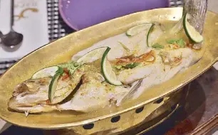  ??  ?? Served in a golden boat, the Pla Gao Neung Ma Nao has a delicious lime sauce with a mild kick.