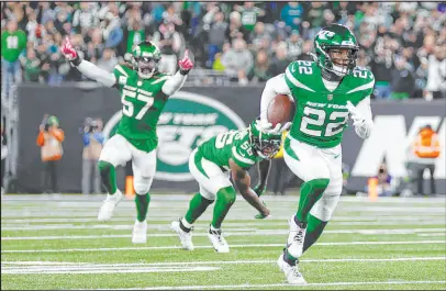  ?? Adam Hunger
The Associated Press ?? Jets safety Tony Adams runs with the ball following a late intercepti­on during Sunday’s game against the Eagles.