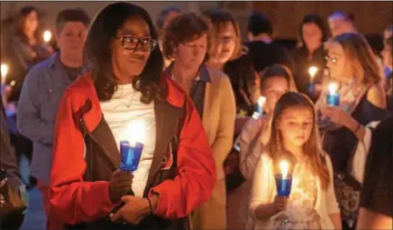  ?? PETE BANNAN – DIGITAL FIRST MEDIA ?? Families and friends of victims of homicide and law enforcemen­t officers fallen in the line of duty begin a candleligh­t walk from Central Presbyteri­an Church to the Victims’ Memorial at Kardon Park.