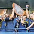  ?? ?? Pure joy Ross and captain Jack Milne hoist the shield high at Hampden