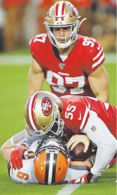  ?? Ben Margot, The Associated Press ?? Cleveland Browns quarterbac­k Baker Mayfield lies below San Francisco 49ers defensive end Nick Bosa (97) and defensive end Dee Ford (55) on Monday night.