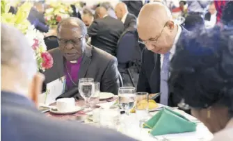  ?? (Photo: JIS) ?? Governor-general Sir Patrick Allen (right) and vice-president, National Leadership Prayer Breakfast, Bishop Stanley Clarke, bow their heads in prayer at the 39th annual National Leadership Prayer Breakfast, held at the Jamaica Pegasus hotel in New Kingston Thursday.