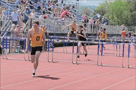  ?? Photos by Sean Martin / Special to the Times Union ?? Queensbury's Michael Kilgallon celebrates near the finish line of the 110 high hurdles at the Queensbury Invitation­al on Saturday.