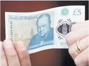  ??  ?? > The new £5 note featuring Winston Churchill