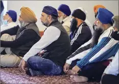  ?? Michael Conroy / Associated Press ?? Sikh Coalition members gather Saturday at Sikh Satsang of Indianapol­is to form the group’s response to the shooting at a Fedex facility that claimed the lives of four Sikhs.