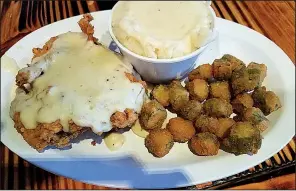  ?? Special to the Democrat-Gazette/ANN BLAYLOCK ?? An excellent cream gravy covers the chicken fried steak and mashed potatoes, served with okra, at Woodland Bakery & Bistro.
