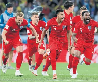  ?? RICARDO MAZALAN/THE ASSOCIATED PRESS ?? Harry Kane, left, and England celebrate midfielder Eric Dier’s spot kick, which lifted the Lions over Colombia and into the World Cup quarterfin­als. The English will next face Sweden, which scored the lone goal in a win over Switzerlan­d.