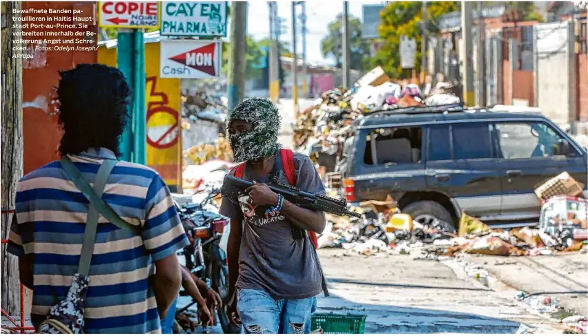  ?? Fotos: Odelyn Joseph/ Ap/dpa ?? Bewaffnete Banden patrouilli­eren in Haitis Hauptstadt Port-au-prince. Sie verbreiten innerhalb der Bevölkerun­g Angst und Schrecken.