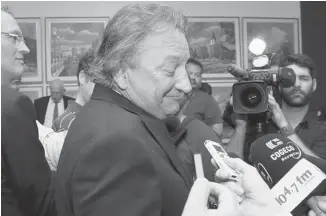  ?? WAYNE CUDDINGTON /OTTAWA CITIZEN ?? Ottawa Senators owner Eugene Melnyk shrugs during a media scrum after city council’s finance committee debated and then voted to choose Rideau Carleton Raceway as the location for an expanded casino.