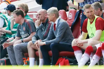  ??  ?? Arsene Wenger takes his seat during the English Premier League football match between Arsenal and West Ham United at the Emirates Stadium in London. — AFP photo