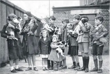  ??  ?? Children queue with their pets outside an early PDSA clinic