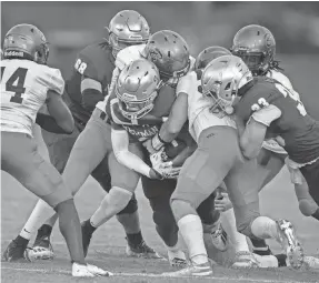  ?? GREG LOVETT/THE PALM BEACH POST ?? Cardinal Newman running back Tovani Mizell is stopped by the Benjamin defense during their game in West Palm Beach, Fla., on Sept. 10, 2021. Mizell committed to UK in June.