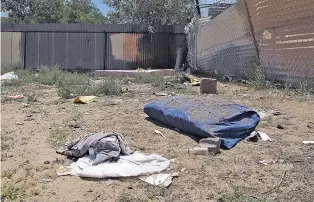  ?? ASSOCIATED PRESS FILE PHOTO ?? Bedding, clothing and broken glass litter a homeless encampment in Albuquerqu­e in 2014, where authoritie­s say three teenagers fatally beat two homeless Navajo men in a crime so alarming it led to the creation of a task force on Native American...