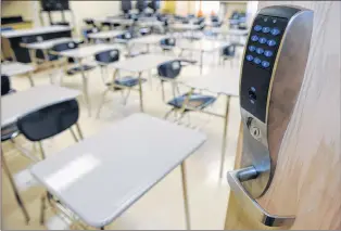  ?? RICHARD ALAN HANNON/THE ADVOCATE VIA AP ?? A bullet-resistant lock installed by Nettalon Security Systems on the door of a classroom at Mckinley Middle Magnet School in Baton Rouge, La.