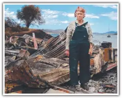  ??  ?? WOES: Artist Gay Hawkes, who says her health declined after the fire, stands in the burnt wreckage of her furniture-making shed.