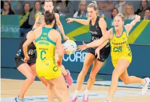  ?? Photo / Photosport ?? Silver Ferns defender Jane Watson is shouldered off the ball by Australia’s Caitlin Bassett.