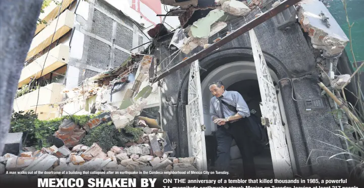  ??  ?? A man walks out of the doorframe of a building that collapsed after an earthquake in the Condesa neighborho­od of Mexico City on Tuesday.