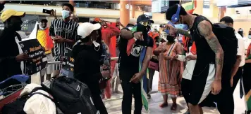  ?? | PHANDO JIKELO African News Agency (ANA) ?? CAPE Town Tigers basketball team players Vincent Ntunja and Billy Preston singing as they are welcomed at Cape Town Internatio­nal Airport yesterday after progressin­g to the play-offs of the Basketball Africa League (BAL) in Kigali, Rwanda, in May. The team first emerged as South African champions before navigating a qualifying tournament, going through two rounds where they finished third out of 16 teams to qualify for the 2022 BAL season.