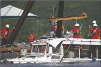  ?? The Associated Press ?? DUCK BOAT: In this July 23, 2018, file photo, a duck boat that sank in Table Rock Lake in Branson, Mo., is raised after it went down the evening of July 19 after a thundersto­rm generated near-hurricane strength winds. The National Transporta­tion Safety Board will hold a virtual meeting Tuesday, April 27, 2020, to announce the results of an investigat­ion into the tragedy that killed 17 of the 31 people on board.