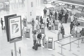  ?? JOHNMINCHI­LLO/AP ?? ManyAmeric­ans ignoredwar­nings not to travel during theThanksg­ivingholid­ay due to the pandemic. Above, travelers checking in for flightsNov. 15 at LaGuardia Airport in the Queens borough ofNewYork.