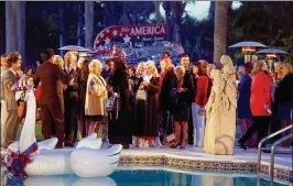  ?? MEGHAN MCCARTHY / THE PALM BEACH POST ?? Guests gather around a pool during the reception in honor of the president; temperatur­es hovered in the 50s and a breeze blew across the lawn from the Intracoast­al Waterway. Heat lamps helped fend off the chill.