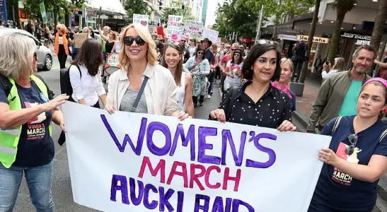  ??  ?? ABOVE: Lizzie Marvelly (in white sleeveless top) walks behind broadcaste­r Ali Mau (at front in sunglasses) along Auckland’s Queen Street on January 21, in a global show of solidarity with those marching in Washington DC.