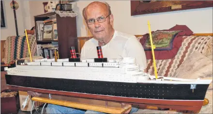  ?? ERIC MCCARTHY/JOURNAL PIONEER ?? Model ship hobbyist Thiren Smallman shows off his model of the Queen Elizabeth passenger ship.