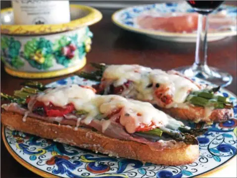  ?? PHOTO BY EMILY RYAN ?? These open-faced asparagus sandwiches feature prosciutto, roasted tomatoes and Gruyëre.