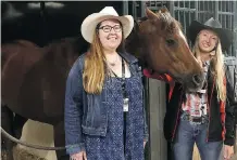  ??  ?? Jessica Melville, right, took Labour Minister Christina Gray and a group of teachers through the chuckwagon barns and taught them the history of the races. Melville comes from a long line of chuckwagon champions.