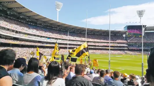  ?? ANJANA SENTHIL ?? Quite popular: Fans cheeering at an Australian Rules football match between Richmond and Hawthorn at the Melbourne Cricket Ground (MCG). The famed MCG is used for Australian Rules or Footy in the noncricket season. In fact, the crowd record at the MCG is for Footy and not cricket.