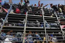  ?? MARCO UGARTE/ AP ?? Central American migrants get a ride on a truck in Celaya, Mexico, on Sunday. Local Mexican officials were helping thousands of migrants find rides on their journey toward the U.S. border.