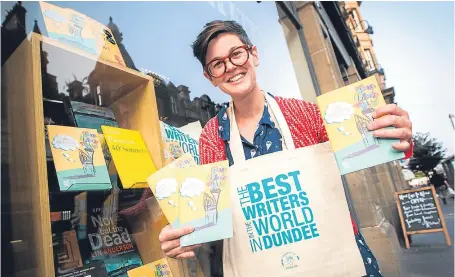  ?? Picture: Steve MacDougall. ?? Peggy Hughes shows off the festival programme at Waterstone­s in Dundee.