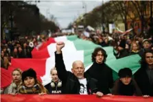  ?? AP PHOTO/DENES ERDOS ?? People carry a huge Hungarian flag Wednesday, marking the 175th anniversar­y of a failed 1848 uprising in Budapest, Hungary.