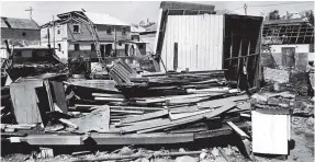  ?? FILE PHOTOS ?? Residents of Lucea were forced to put back together the pieces that Hurricane Gilbert sent flying when it slammed into Jamaica on September 12, 1988. In this picture, The main street was transforme­d into a near-endless pile of rubble and roofless buildings.