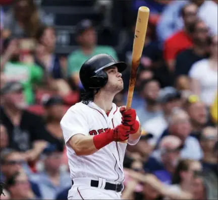  ?? CHARLES KRUPA — THE ASSOCIATED PRESS ?? Andrew Benintendi watches the flight of his RBI double during the sixth inning against the Oakland Athletics at Fenway Park in Boston, Thursday.