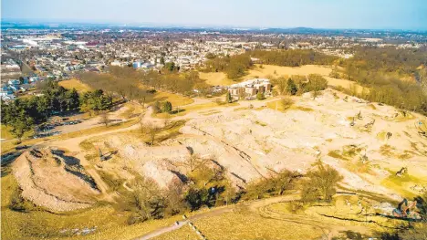  ?? SCOTT M. NAGY/SPECIAL TO THE MORNING CALL ?? The grounds of the former Allentown State Hospital, seen looking northeast. The tree-lined entrancewa­y, center left, leads to Hanover Avenue. A new report examines three buildout scenarios for redevelopm­ent of the site.