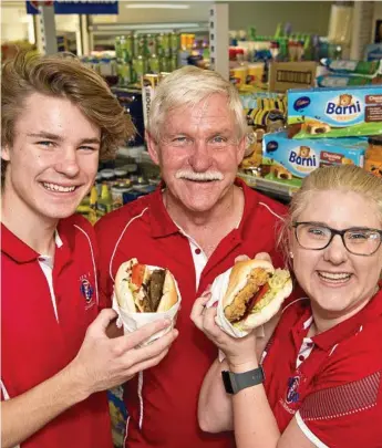  ??  ?? BEST BURGERS: Burgers are a family business at Gowrie One Stop Convenienc­e Centre for Clint Weber (centre) with his son Daniel Weber and daughter Ashleigh Webb.