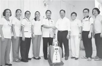  ??  ?? Wong (fifth left) presents the HOT machine to SKF Board of Trustees chairman Temenggong Datuk Vincent Lau (fourth right) as Ivy (third right) and SKF staff look on.