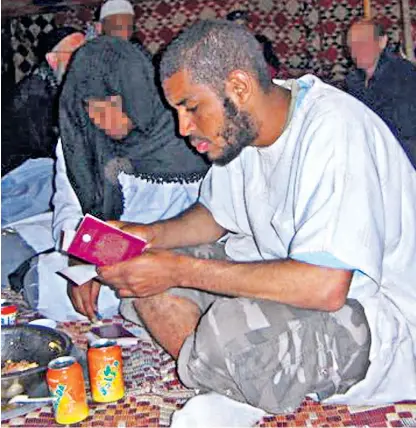  ??  ?? Allexanda Kotey, from west London, with his British passport during the Viva Palestine aid mission organised by Respect MP George Galloway in 2009