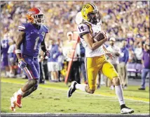  ?? GERALD HERBERT / ASSOCIATED PRESS ?? LSU kicker Trent Domingue runs for a TD in front of defensive back Vernon Hargreaves III on a fake field goal late in Saturday’s game at Baton Rouge. LSU beat Florida 35-28.