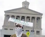  ?? AP FILE PHOTO/MARK HUMPHREY ?? A demonstrat­or calls for the bust of Nathan Bedford Forrest, which is displayed in the state capitol, to be taken down as she protests across the street from the capitol last week in Nashville.