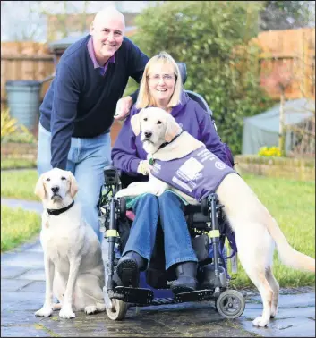  ??  ?? Kate Cross with husband Stuart, retired assistance dog Byron and new assistance dog from charity Canine Partners, May in the purple jacket.